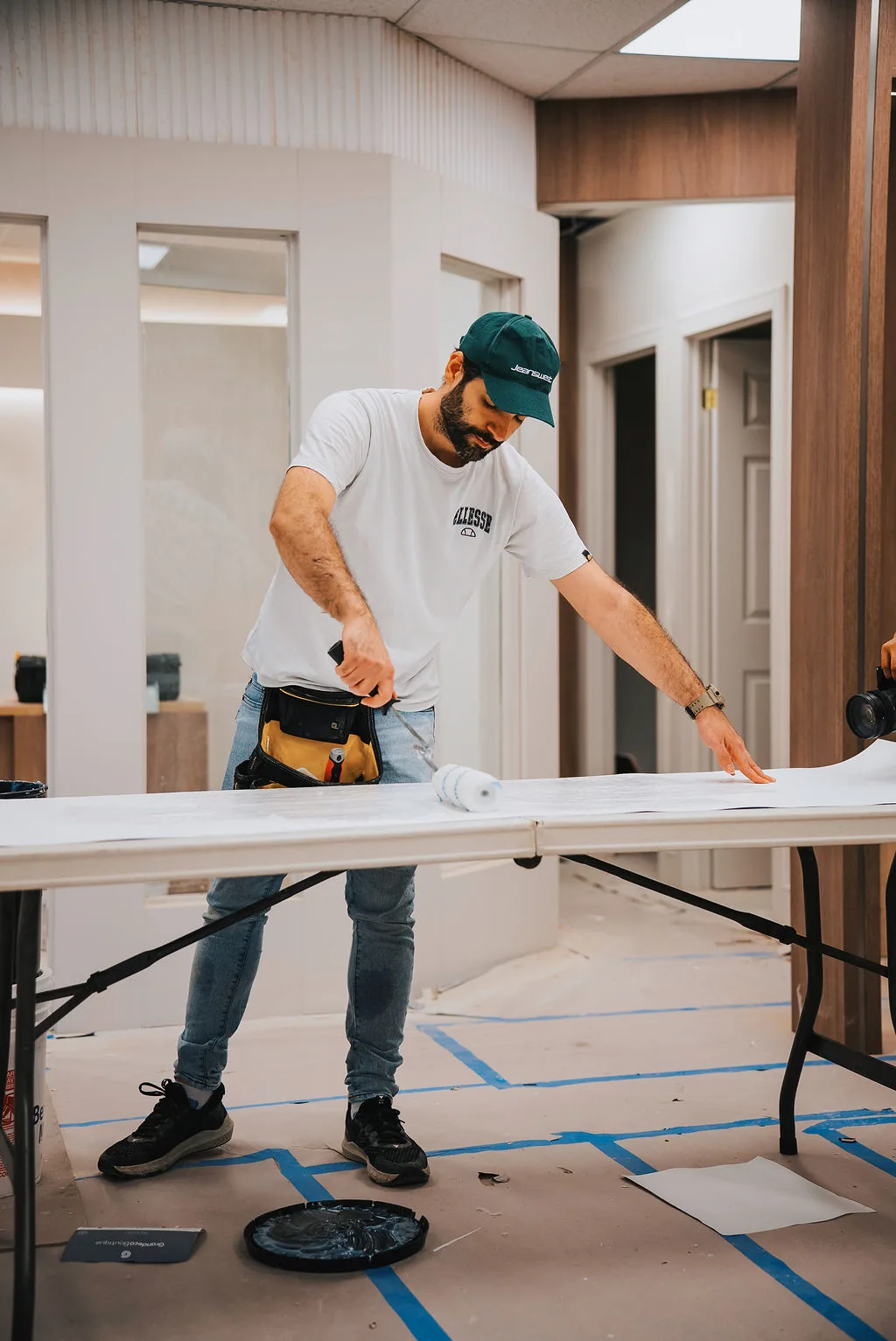Datis Wallpaper installer preparing a wallpaper strip during a Greater Toronto Area project